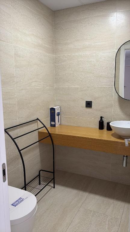 a bathroom with a toilet and a sink at LHOME CÁDIZ in Cádiz
