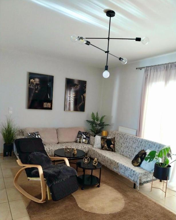 a living room with a couch and chairs and a table at Olga apartment in Chalkida
