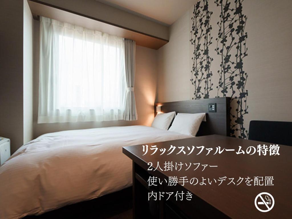 Postel nebo postele na pokoji v ubytování 今治ステーションホテル