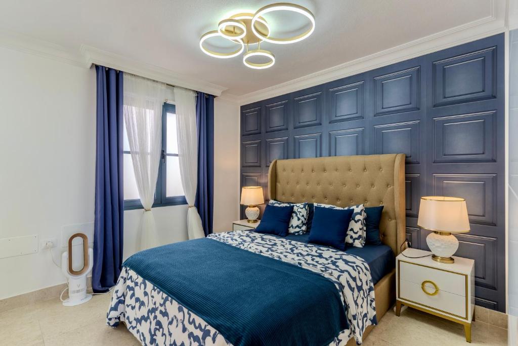 a bedroom with blue walls and a blue bed at Charming semi- detached villa in Mirador del Duque in Adeje