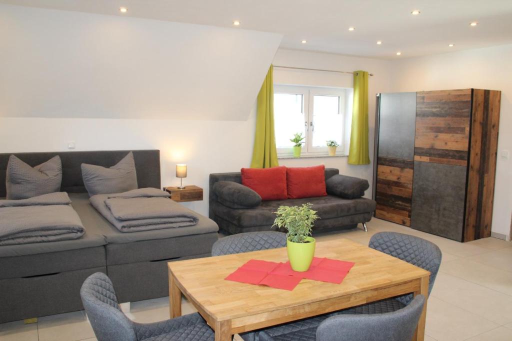 a living room with a couch and a table at Apartment Alter Stern Rothenburg ob der Tauber in Rothenburg ob der Tauber