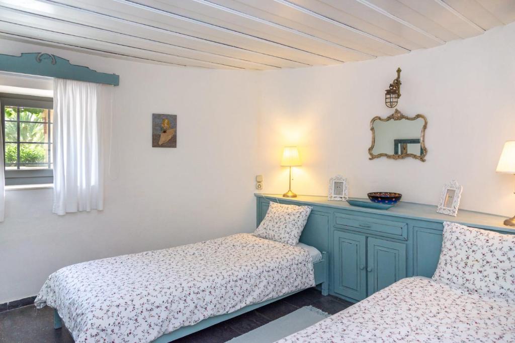 A bed or beds in a room at Authentic Cretan Stone Windmill