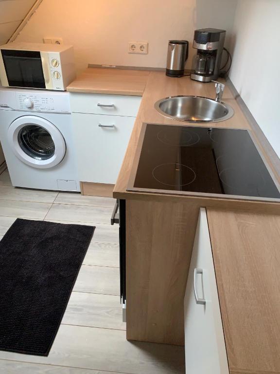 a kitchen with a sink and a microwave at Studio 29 in Oberhausen