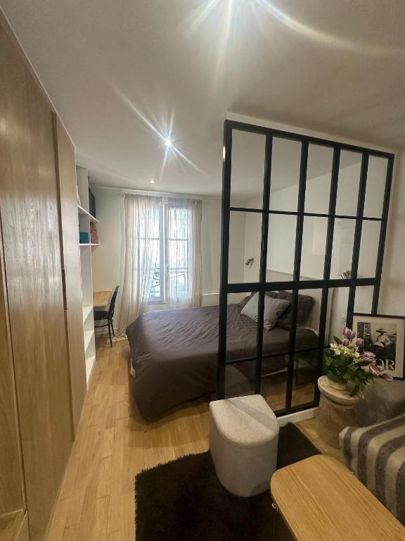 une chambre avec un grand lit et un canapé dans l'établissement Studio champs Elysée, à Paris