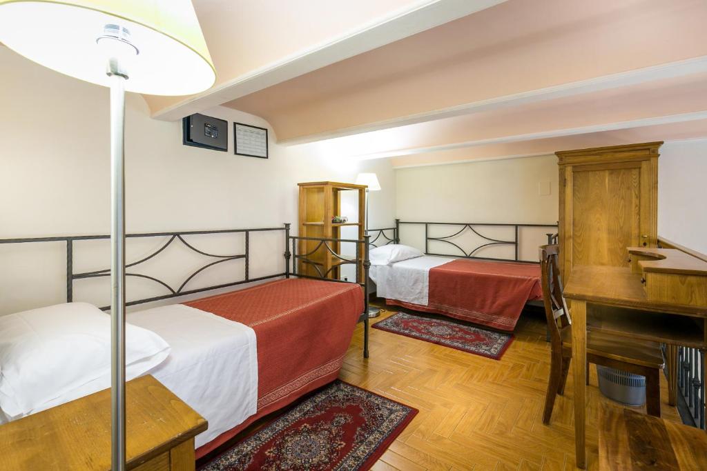 Postel nebo postele na pokoji v ubytování Hotel Collodi Firenze