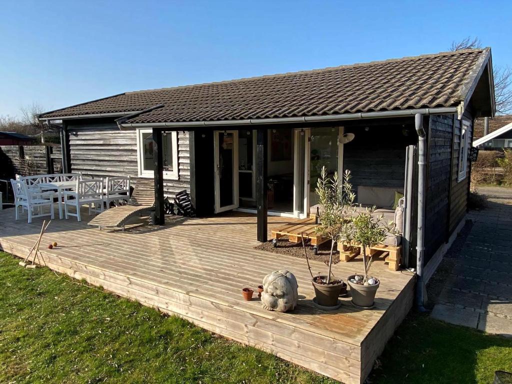 a wooden deck in front of a house at Lovely House With Sea View And Large Terrace in Karrebæksminde