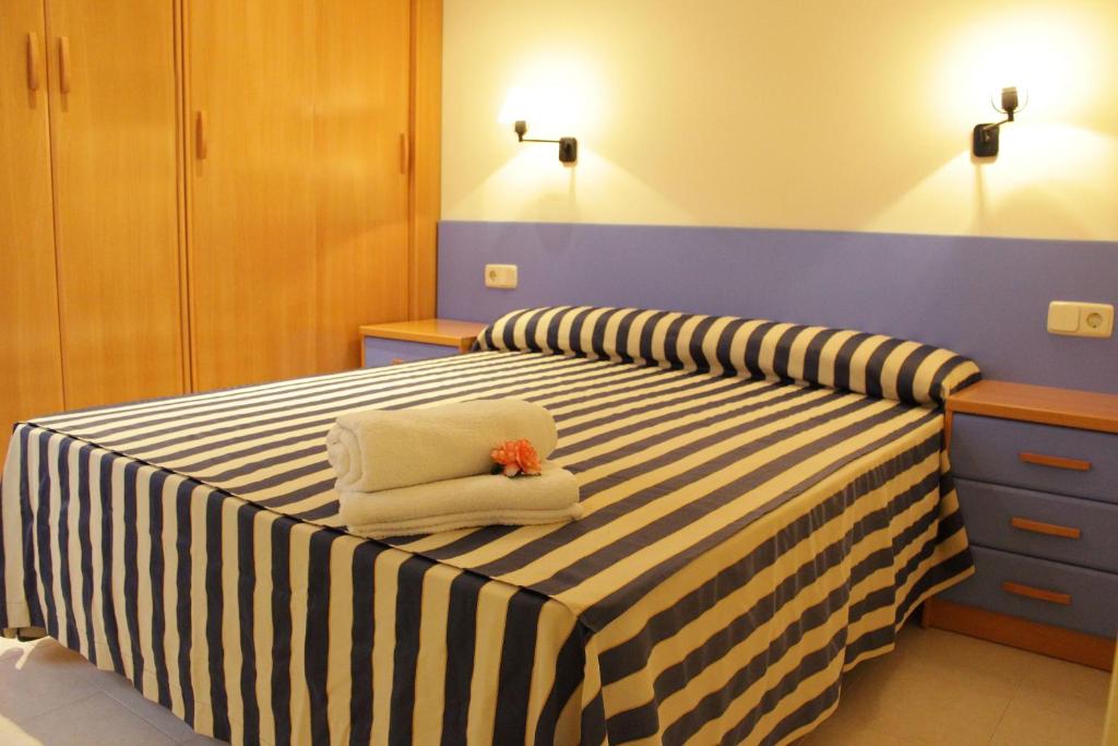 a bedroom with two beds with towels on them at Apartaments Tamariu in Tamariu