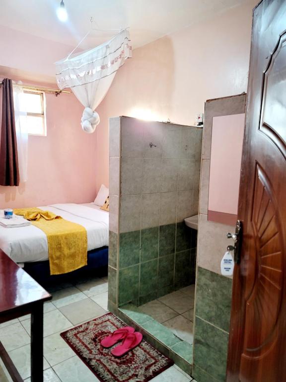 Postel nebo postele na pokoji v ubytování Sislink Hotel Nairobi