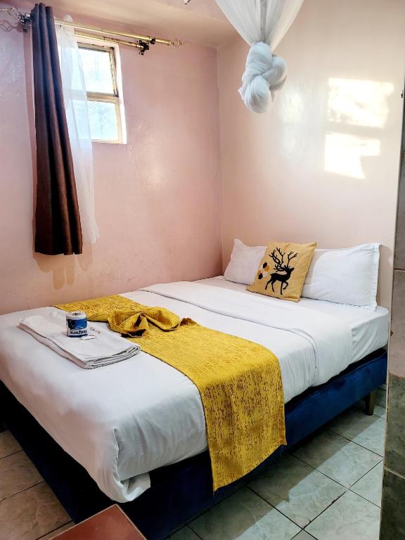 Postel nebo postele na pokoji v ubytování Sislink Hotel Nairobi