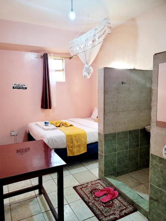 Postel nebo postele na pokoji v ubytování Sislink Hotel Nairobi
