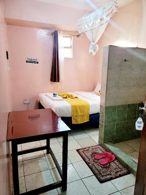Postel nebo postele na pokoji v ubytování Sislink Hotel Nairobi