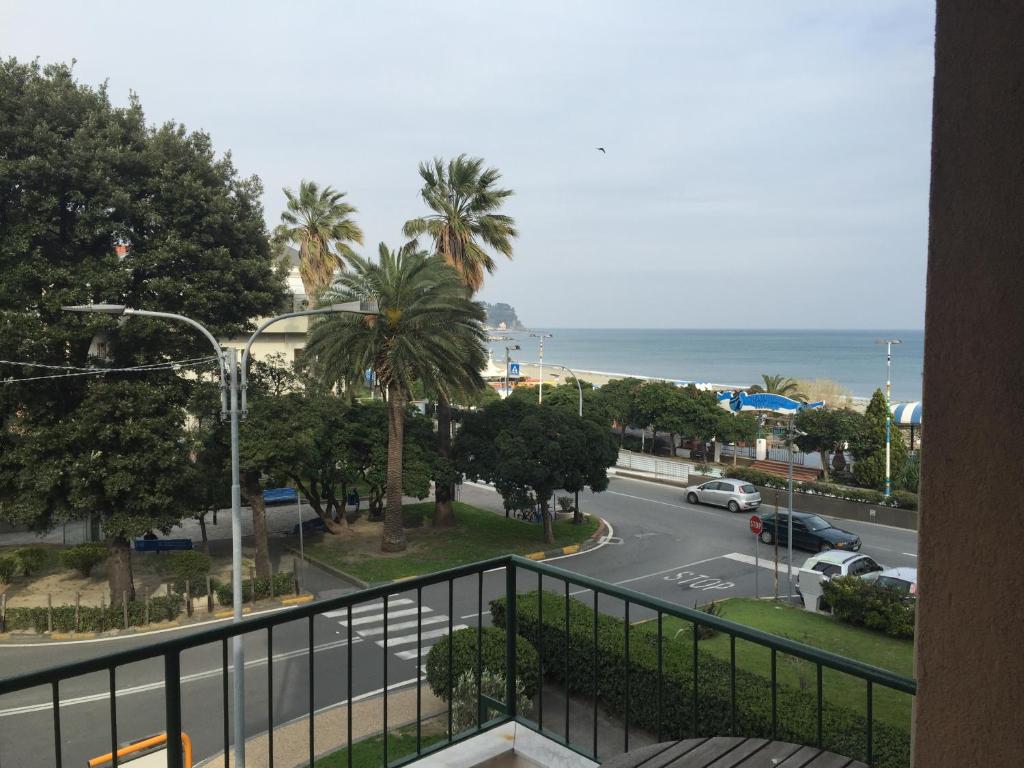 a balcony with a view of a street and the ocean at Hotel Nuovo Metropol in Albissola Marina