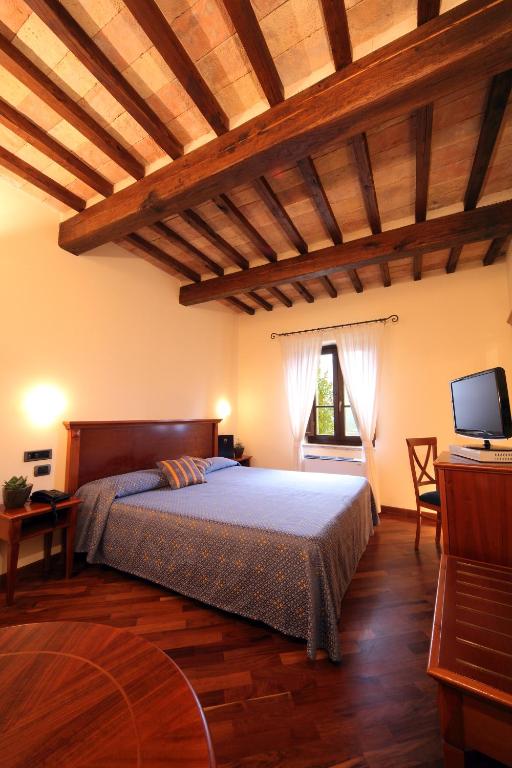 Postel nebo postele na pokoji v ubytování Relais La Corte di Bettona