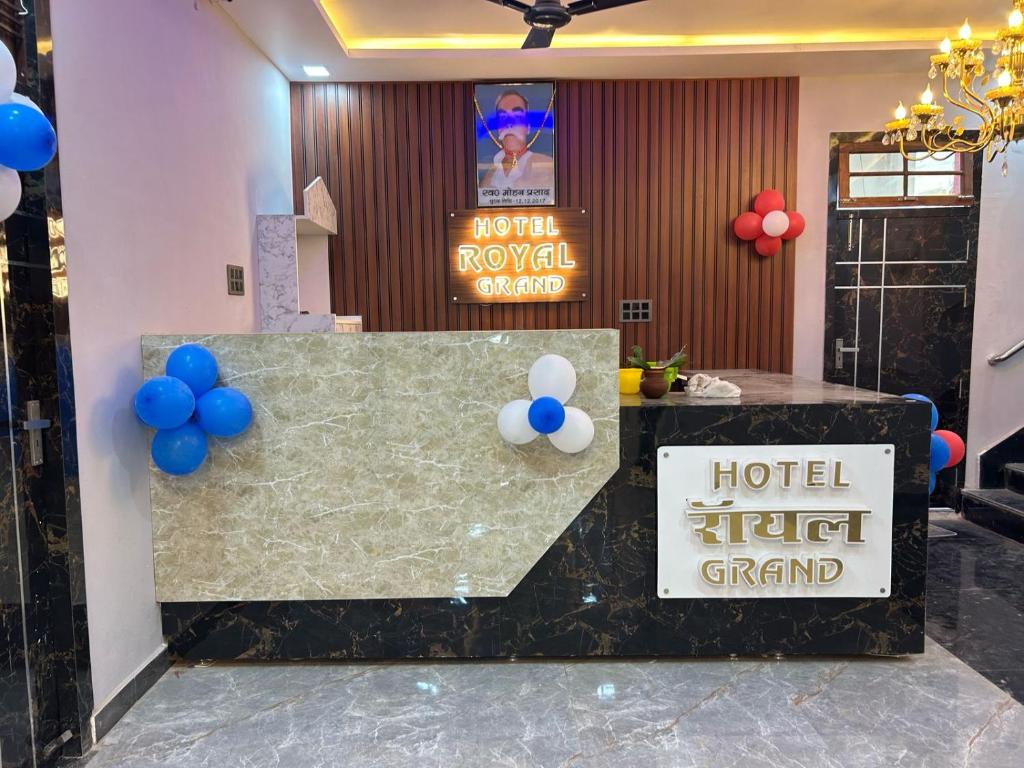 a hotel lobby with a reception desk with blue and white balloons at Hotel Royal Grand in Gomti Nagar