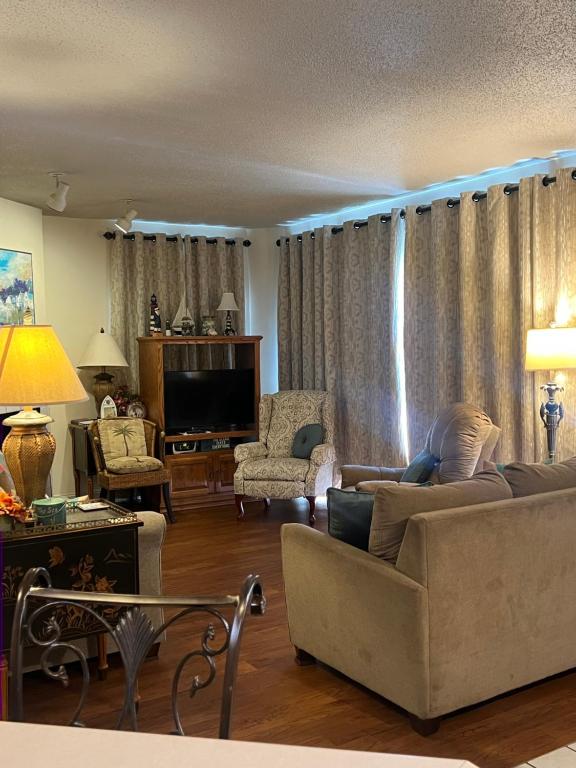 a living room with a couch and a tv at River Place Condos #110 3BD in Pigeon Forge