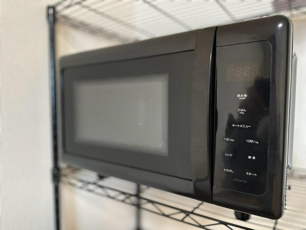 TV a/nebo společenská místnost v ubytování ハレノヒハクシマ