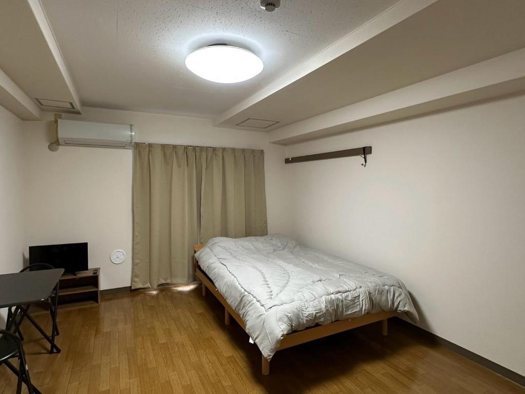 Postel nebo postele na pokoji v ubytování ハレノヒハクシマ