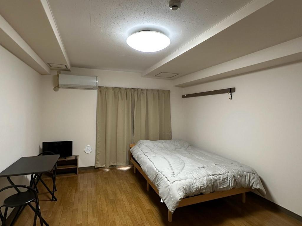 Postel nebo postele na pokoji v ubytování ハレノヒハクシマ