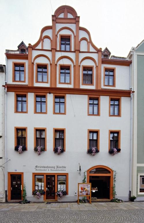 a large white building with brown trim at Ferienwohnungen Familie Jäschke in Görlitz