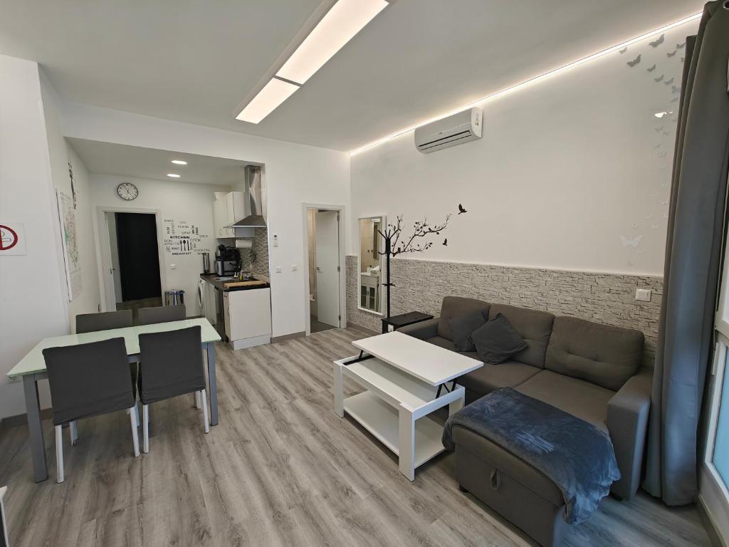 a living room with a couch and a table at Zona muy tranquila todo nuevo in Madrid