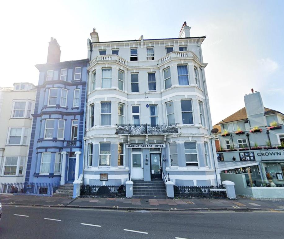 a large white building on the corner of a street at Marine Parade Hotel by PLI in Eastbourne