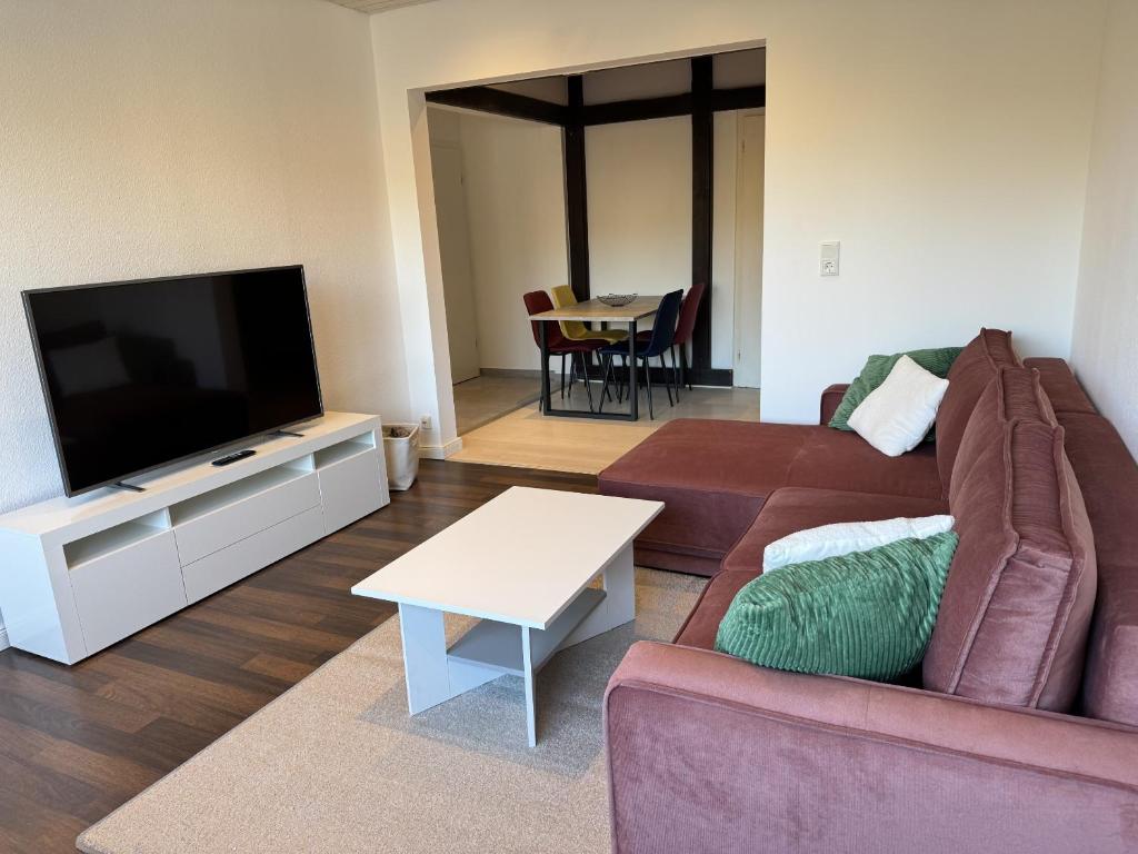 a living room with a couch and a flat screen tv at Ferienwohnung Arminius in Detmold