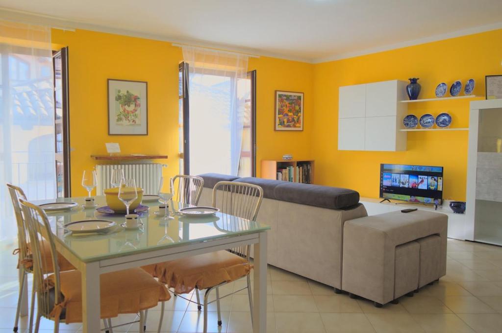 a living room with a table and a couch at Casa Gialla Soggiorno Panorama in Centro Storico in Dogliani