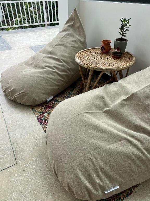 two pillows sitting on the floor next to a table at Calma - Surf, Yoga & Coffee on a Private Beach in Dickwella