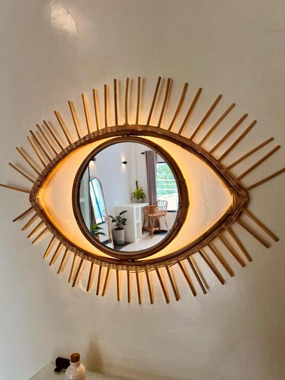a mirror on the wall of a room with a table at Calma - Surf, Yoga & Coffee on a Private Beach in Dickwella