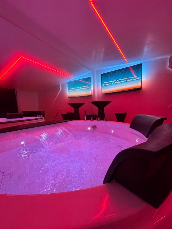 a hot tub in a room with red lights at Elite Suite in Castellana Grotte
