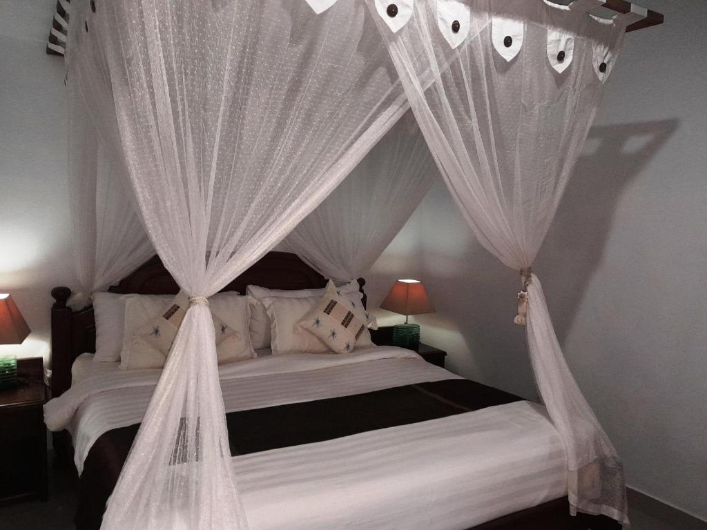 Postel nebo postele na pokoji v ubytování Pondok Dauh Ancak Kelating Guest House