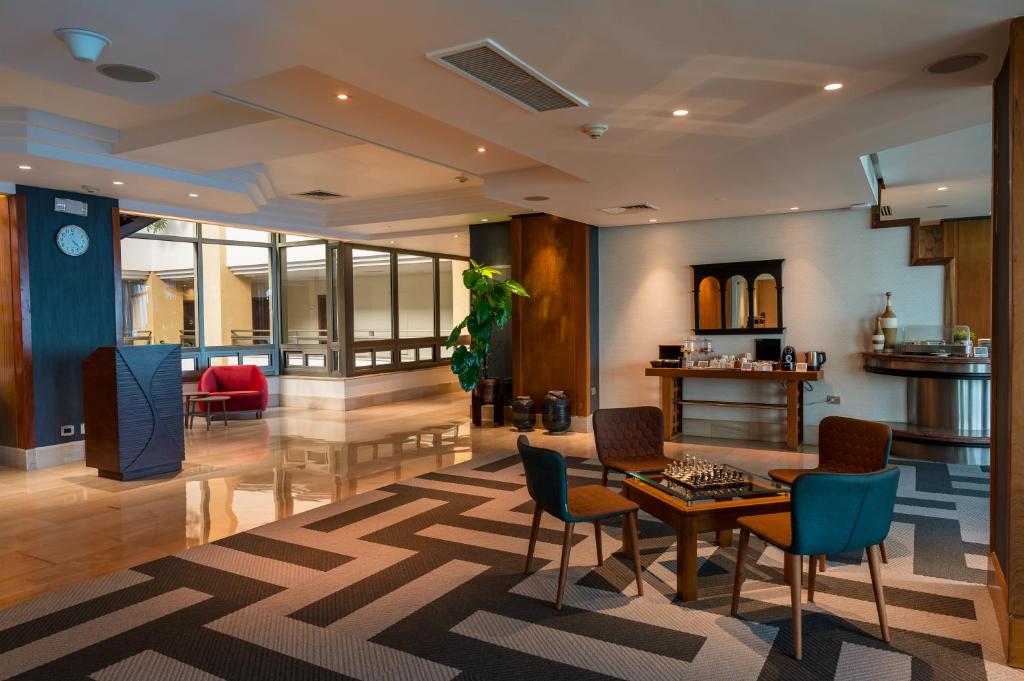 a living room with a table and chairs at Catalonia Santo Domingo in Santo Domingo