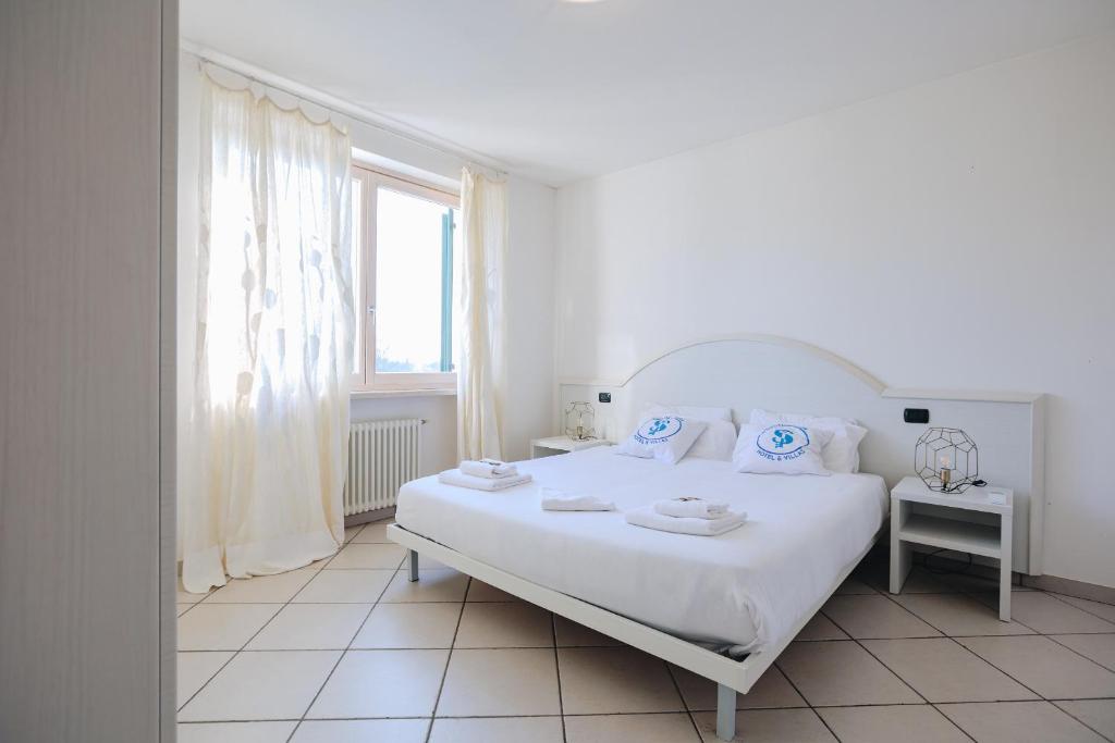 Łóżko lub łóżka w pokoju w obiekcie Residenza Pastrengo