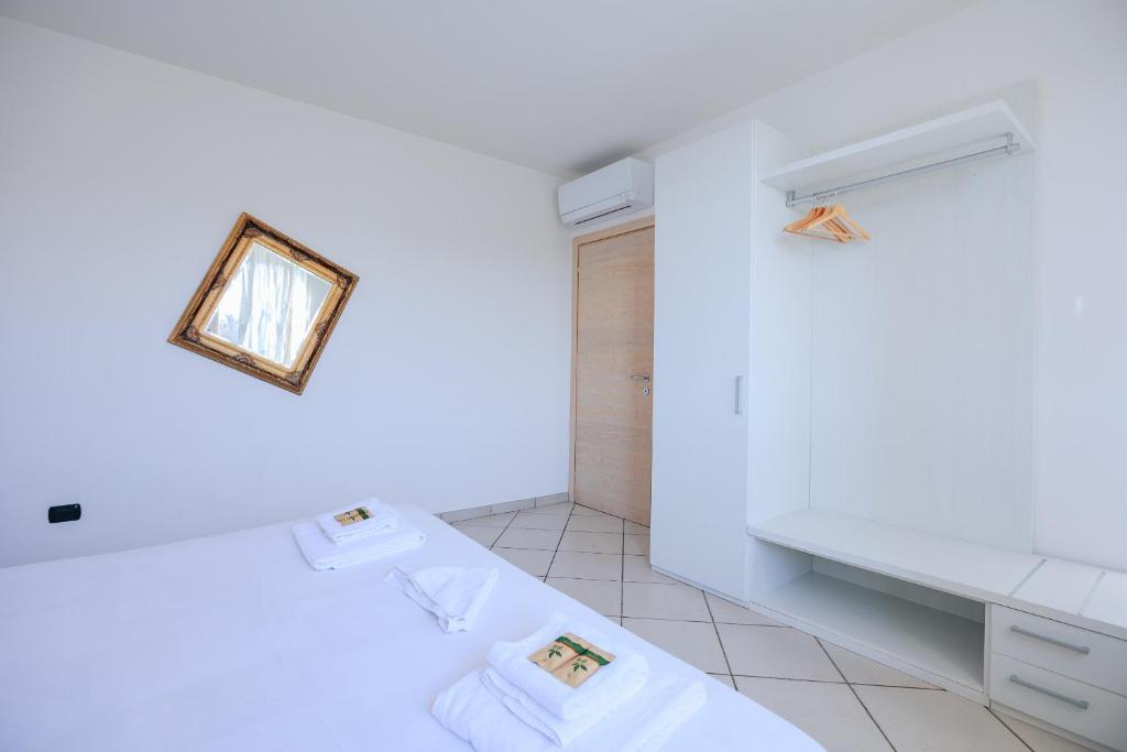 Łóżko lub łóżka w pokoju w obiekcie Residenza Pastrengo