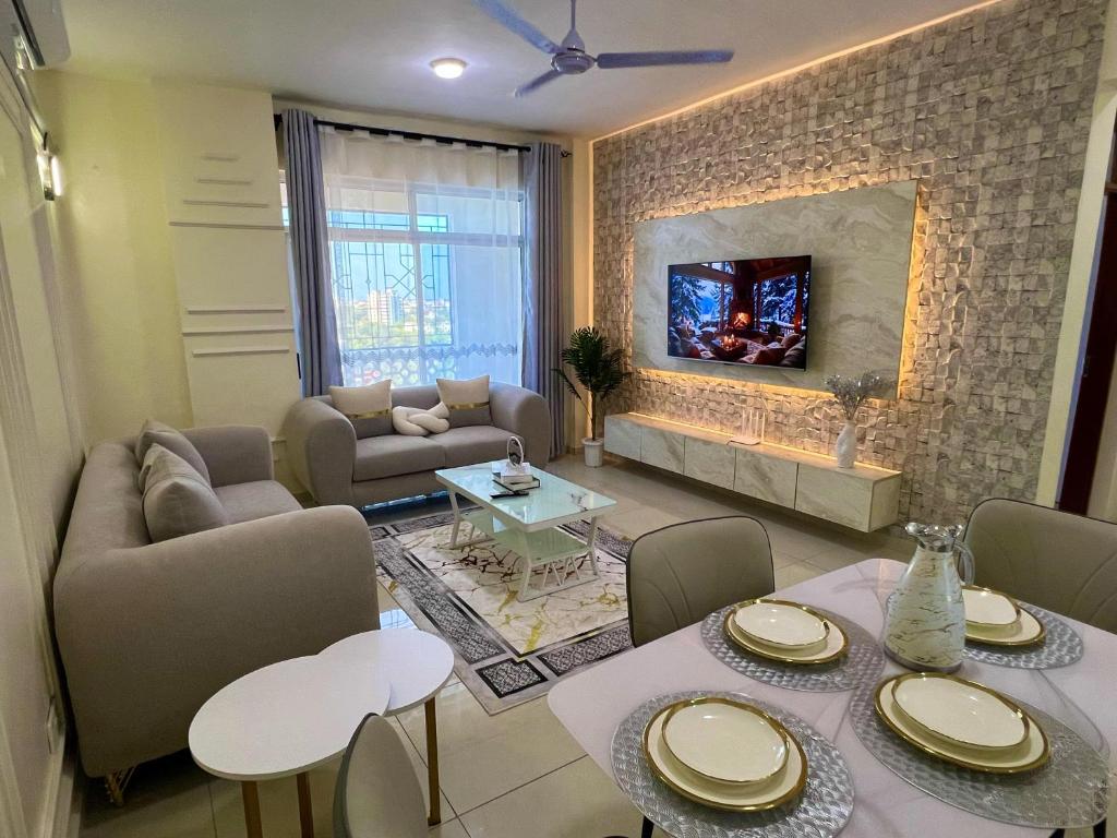 a living room with a table and a fireplace at Two Bedroom, City View Apartment, Bondeni, Mombasa in Mombasa