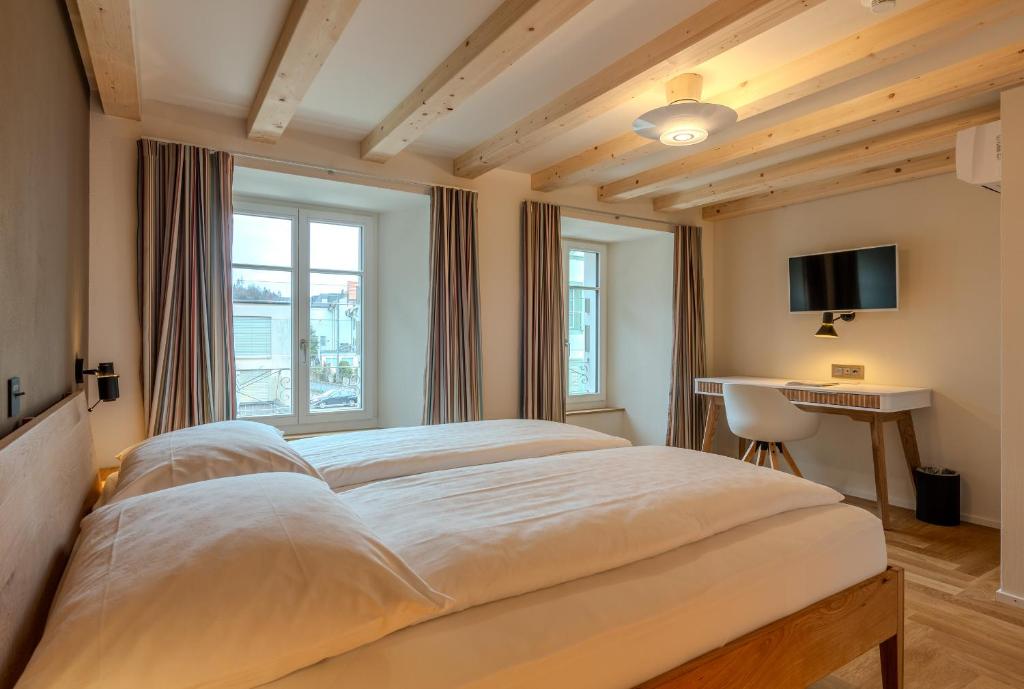 a bedroom with a large bed and a television at Alplodge in Interlaken