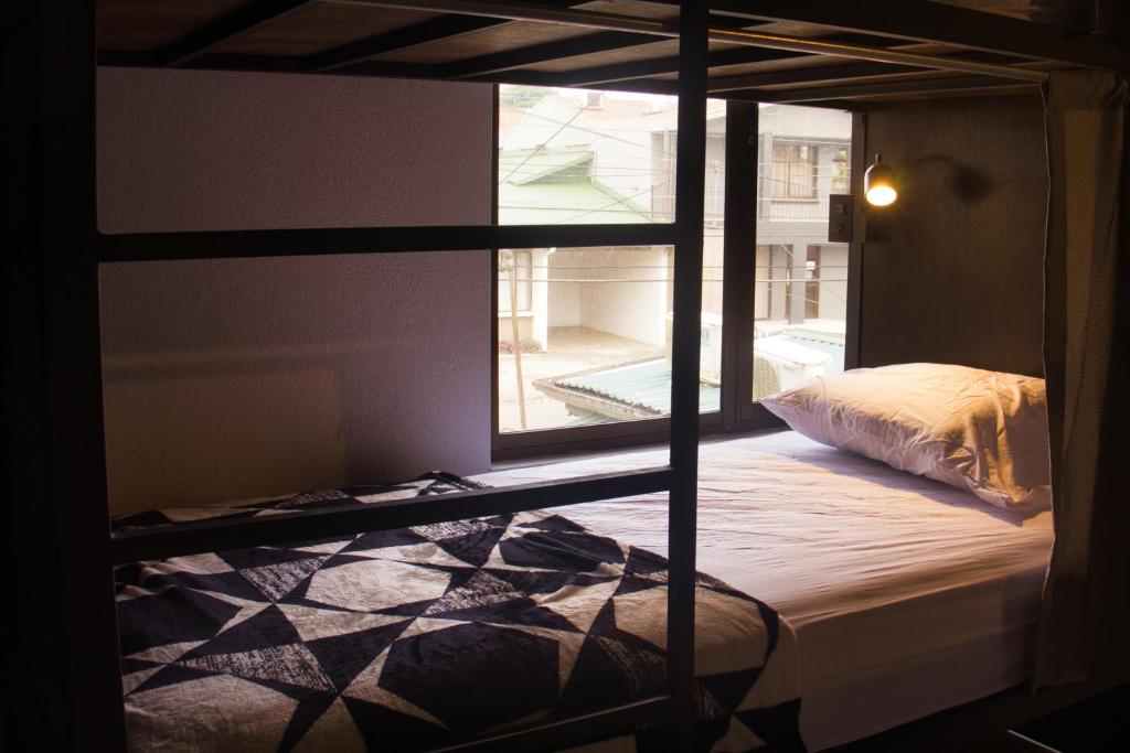 Postel nebo postele na pokoji v ubytování Ceiba Hostel