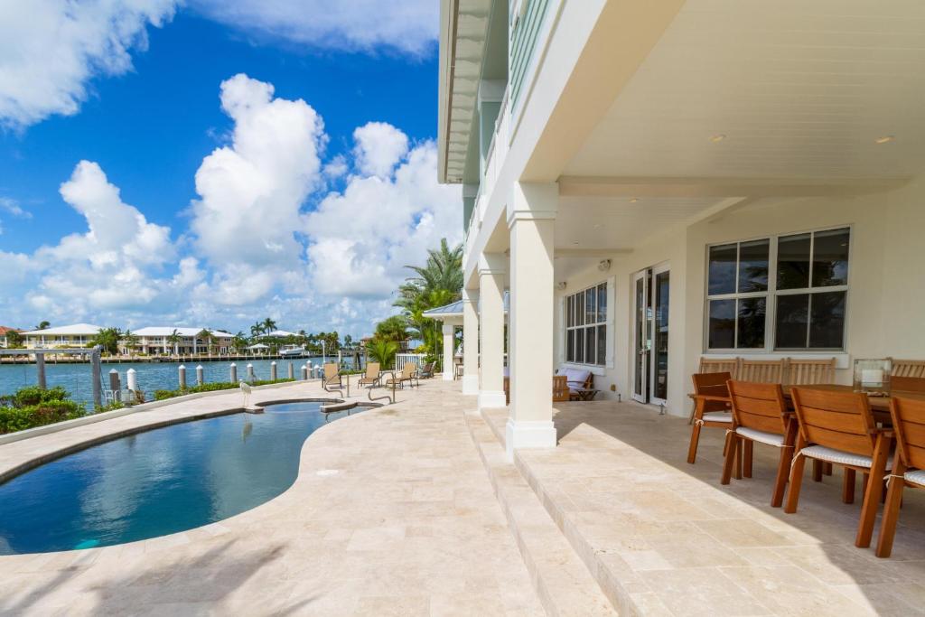 a house with a swimming pool and a patio at The Vaca House in Marathon