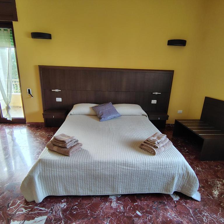 a bedroom with a large bed with two pillows on it at Dimora Costa Del Sole in Gallipoli