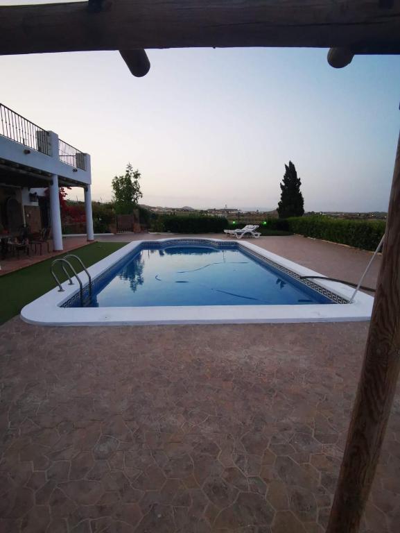 a swimming pool in the middle of a patio at Villa Calamaco in Los Gallardos