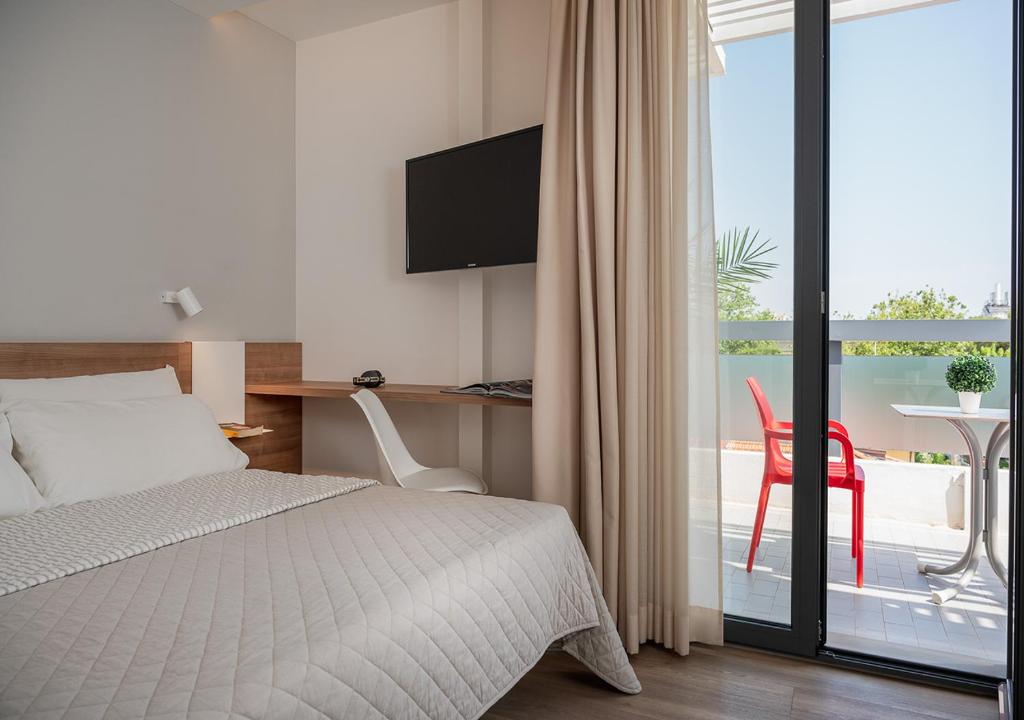 En eller flere senge i et værelse på Riccione Beach Hotel-Vero'Boutique Hotel-