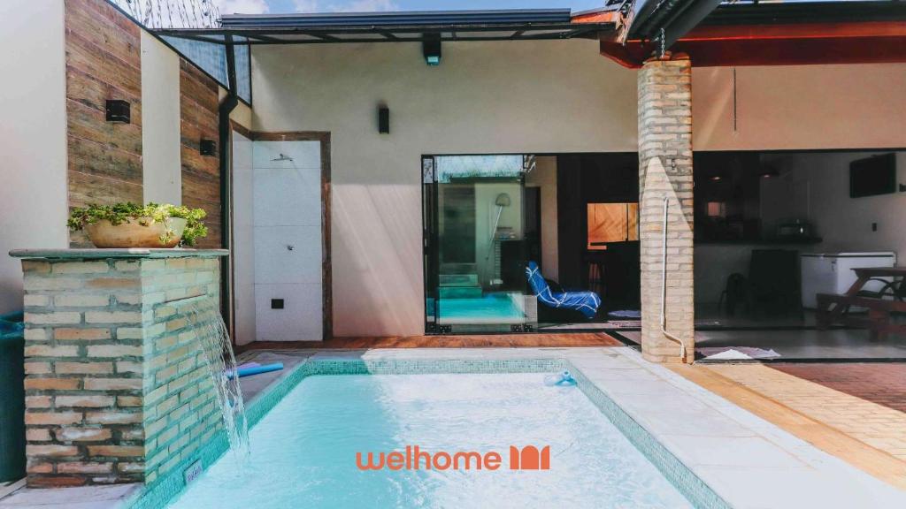 a swimming pool in front of a house at Casa incrivel em Bebedouro com piscina e lazer in Bebedouro