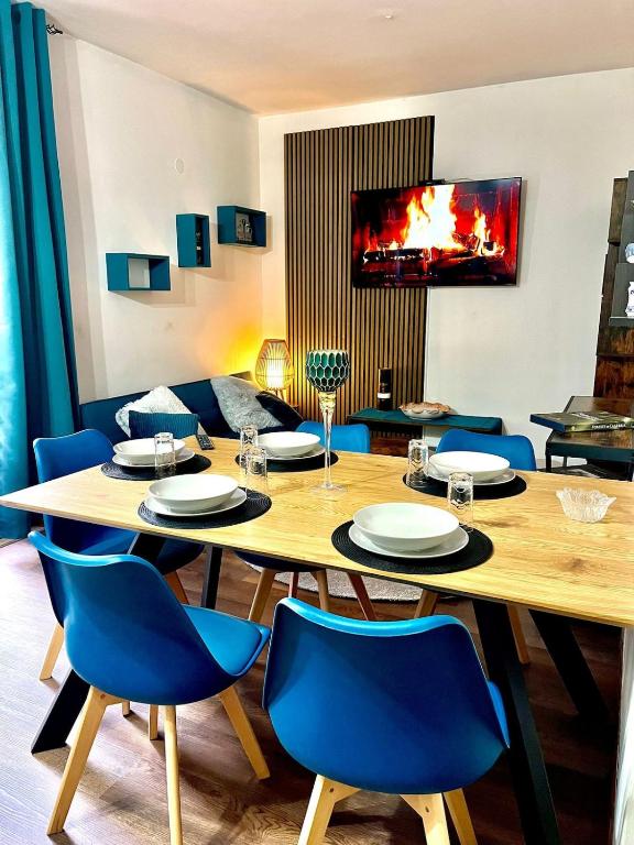 a dining room with a table and blue chairs at Casa Bucaneve in Camigliatello Silano