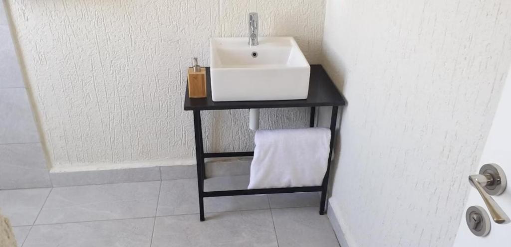 a bathroom with a sink on a black table at Halle Hotel - Lalibela in Lalībela