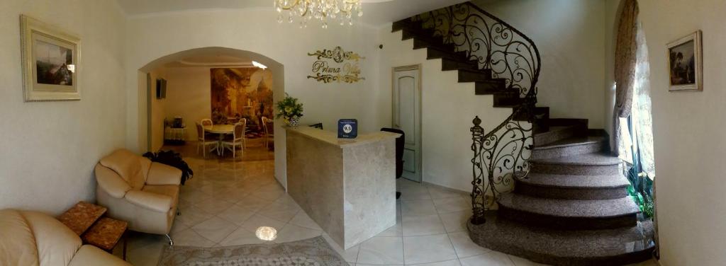 una sala de estar con una escalera de caracol en una casa en Prima Villa Guest House, en Vínnytsia