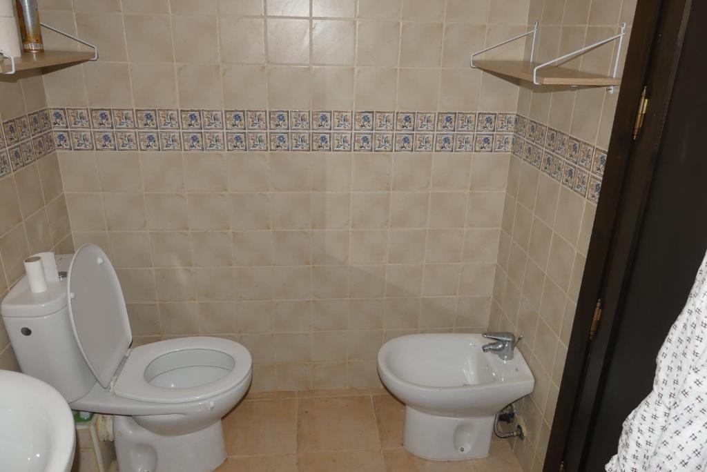 a bathroom with a toilet and a sink at RESIDENCE AL ANDALUS AP4 SAIDIA in Saidia 