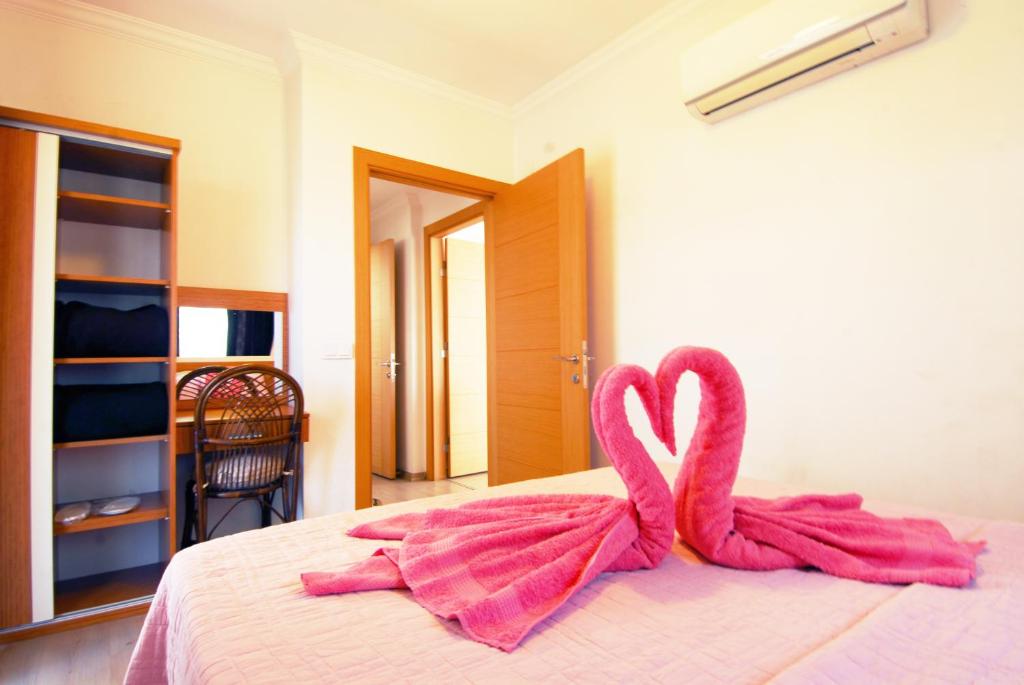 two towels in the shape of hearts are on a bed at Lidya City Hotel in Fethiye