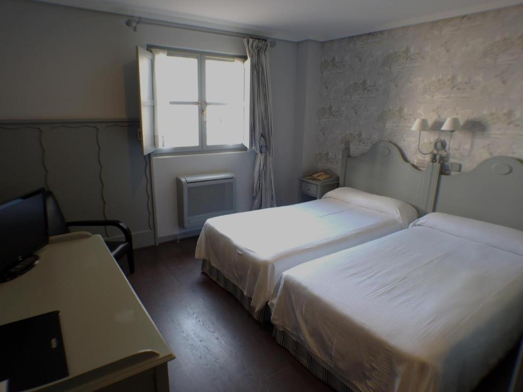 Cama o camas de una habitación en Hotel Comillas