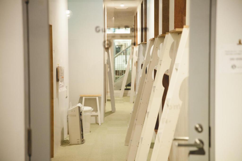 a hallway with a row of stalls in a hospital at Guest House MARUYA in Atami