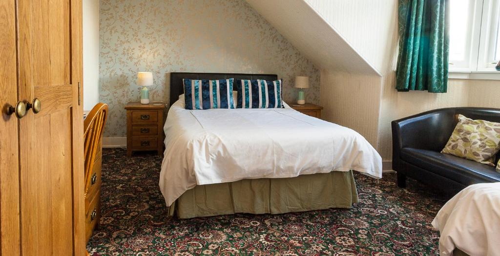 A bed or beds in a room at Bank Guest House